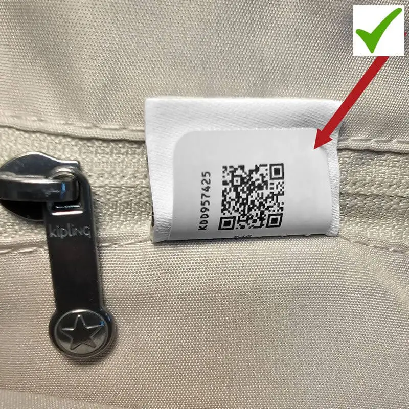 Original Kipling bag authenticity tag with QR code and serial number inside the lining.