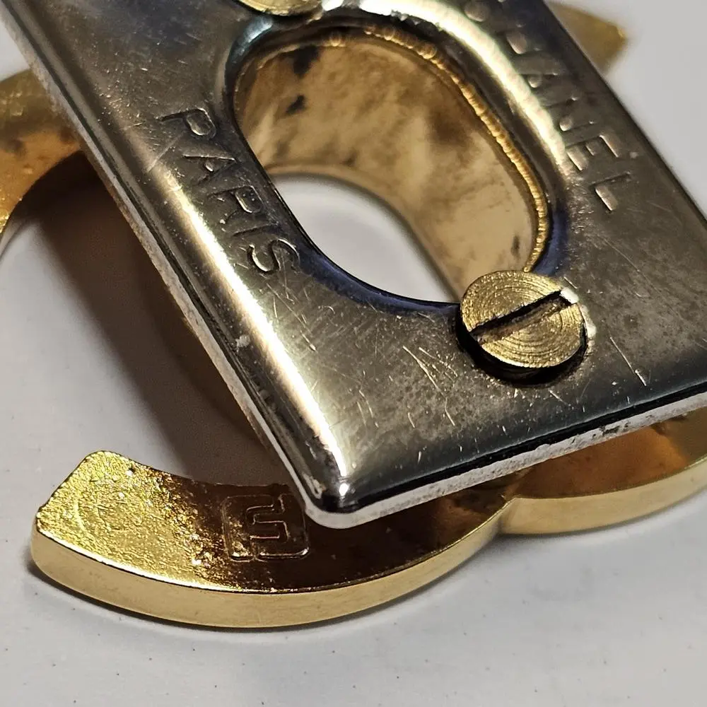 FA factory marking on authentic Chanel CC lock hardware close-up